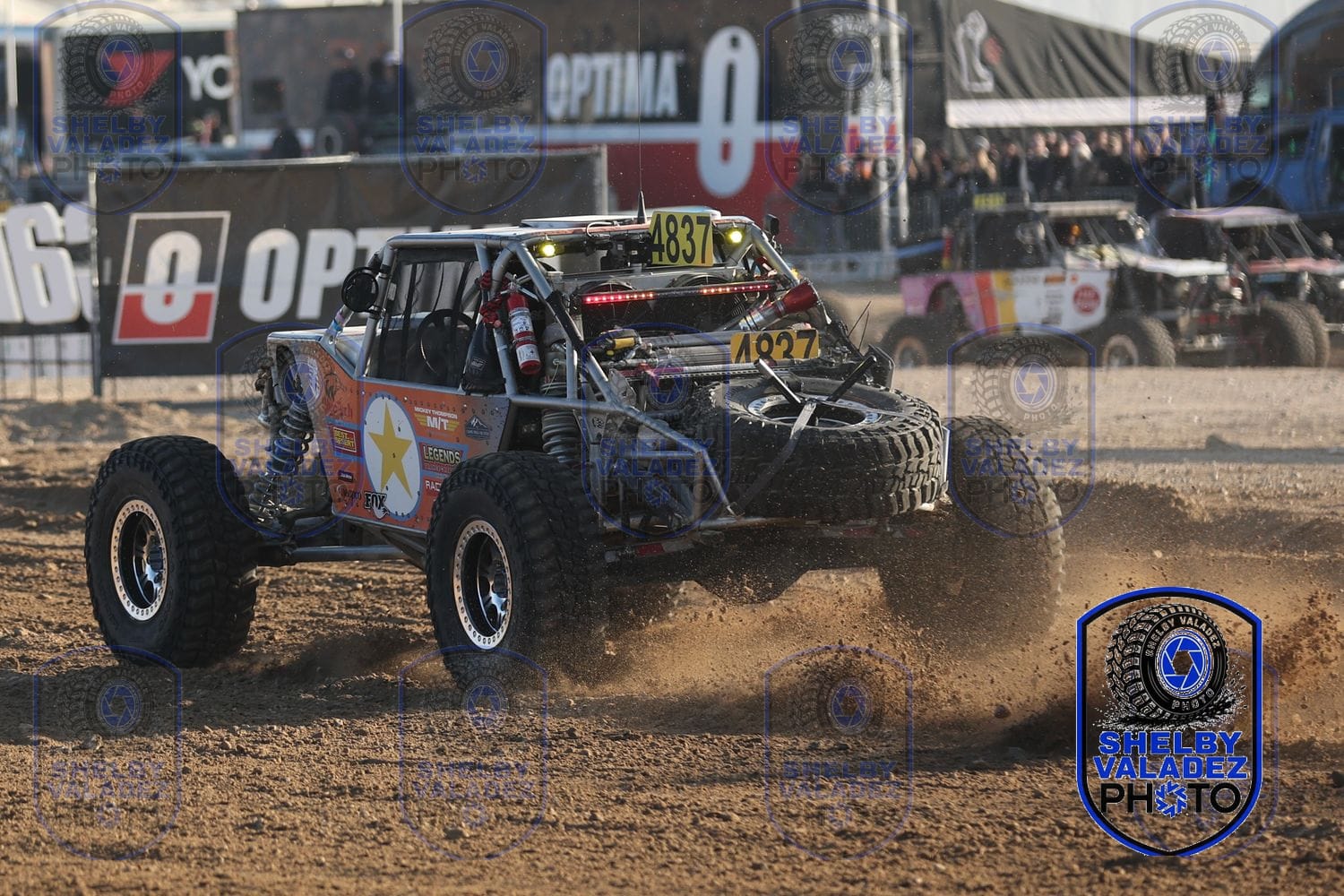 Ultra4 car number 4327 racing past the OPTIMA banners at LS Fest