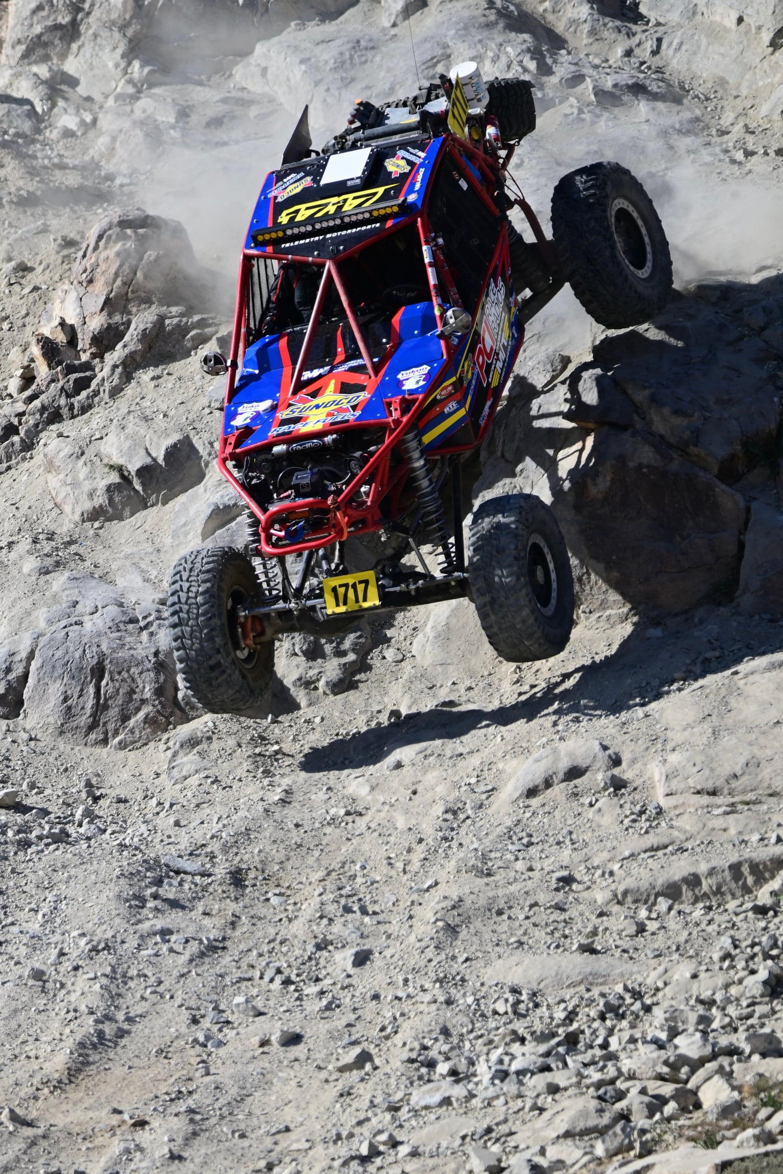 Rock crawler climbing a steep boulder field at King of the Hammers